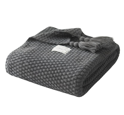Fringed knitting blanket in beige colour showing 5cm fringe detailing and dense acrylic weave texture