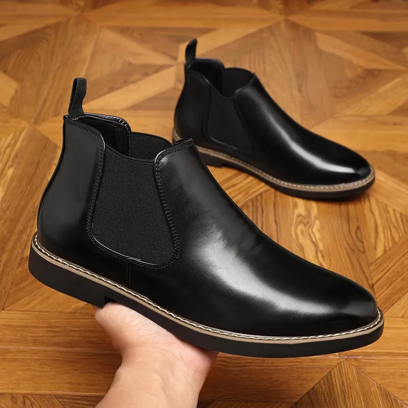 A pair of formal black leather pointed-toe boots with a square heel and rubber sole