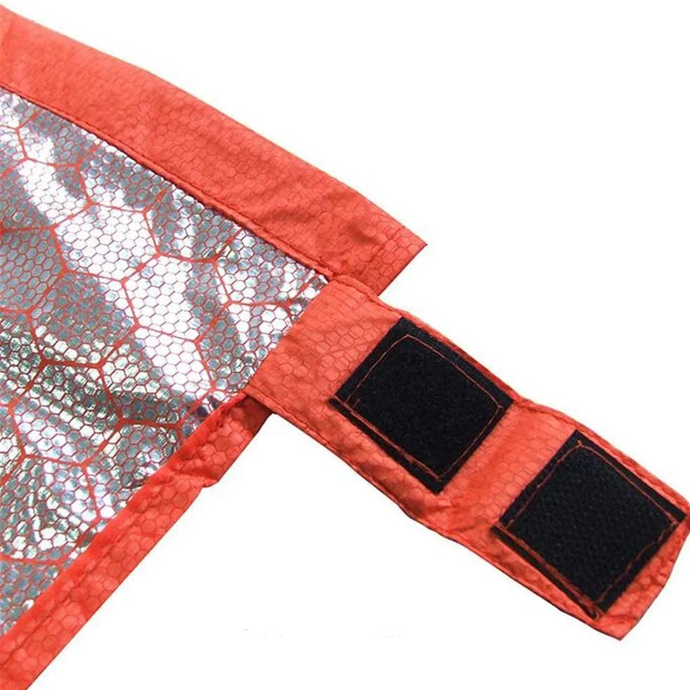 Orange outdoor thermal sleeping bag with silver coated nylon showing envelope design and storage bag