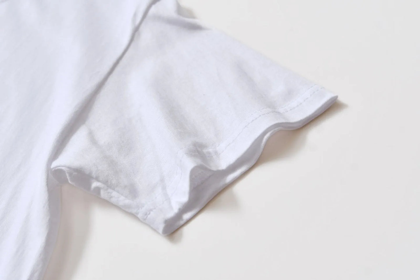 White cotton T-shirt style overalls with short sleeves and loose fit pullover design