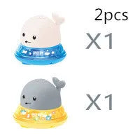 Grey or white electric whale bath toy spraying water with LED lights on a base.