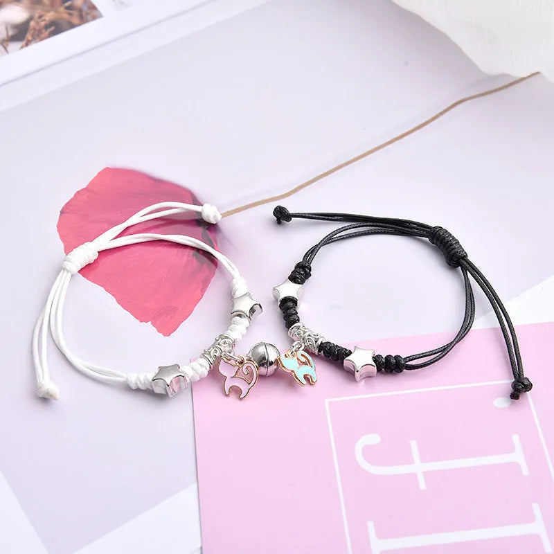 A pair of magnet couple bracelets with a suction clasp, showing various design options like clovers, crowns, and hearts.
