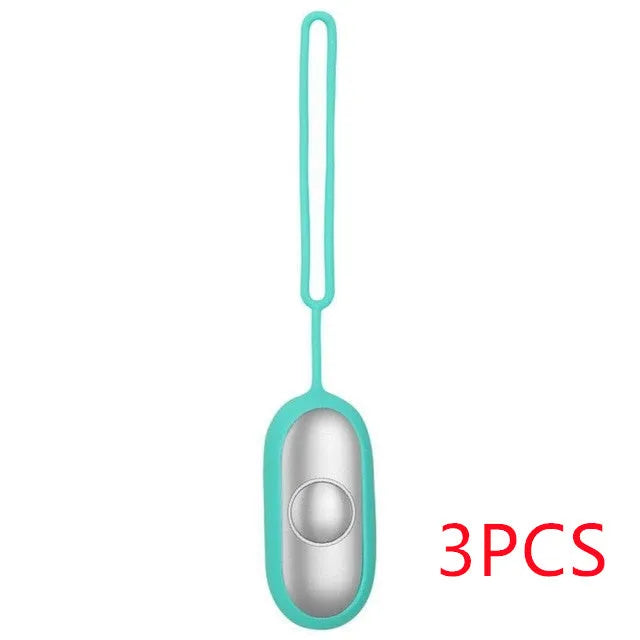 Hand-held micro-current sleep aid device in grey, green, or orange with round button and USB charging port