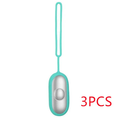 Hand-held micro-current sleep aid device in grey, green, or orange with round button and USB charging port