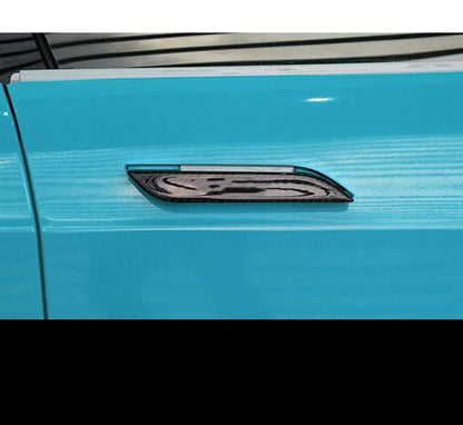 Set of four carbon fibre texture adhesive door handle protectors for Tesla Model S interior.
