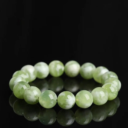 Green milk-in-water Xiuyan jade bracelet with polished geometric beads.