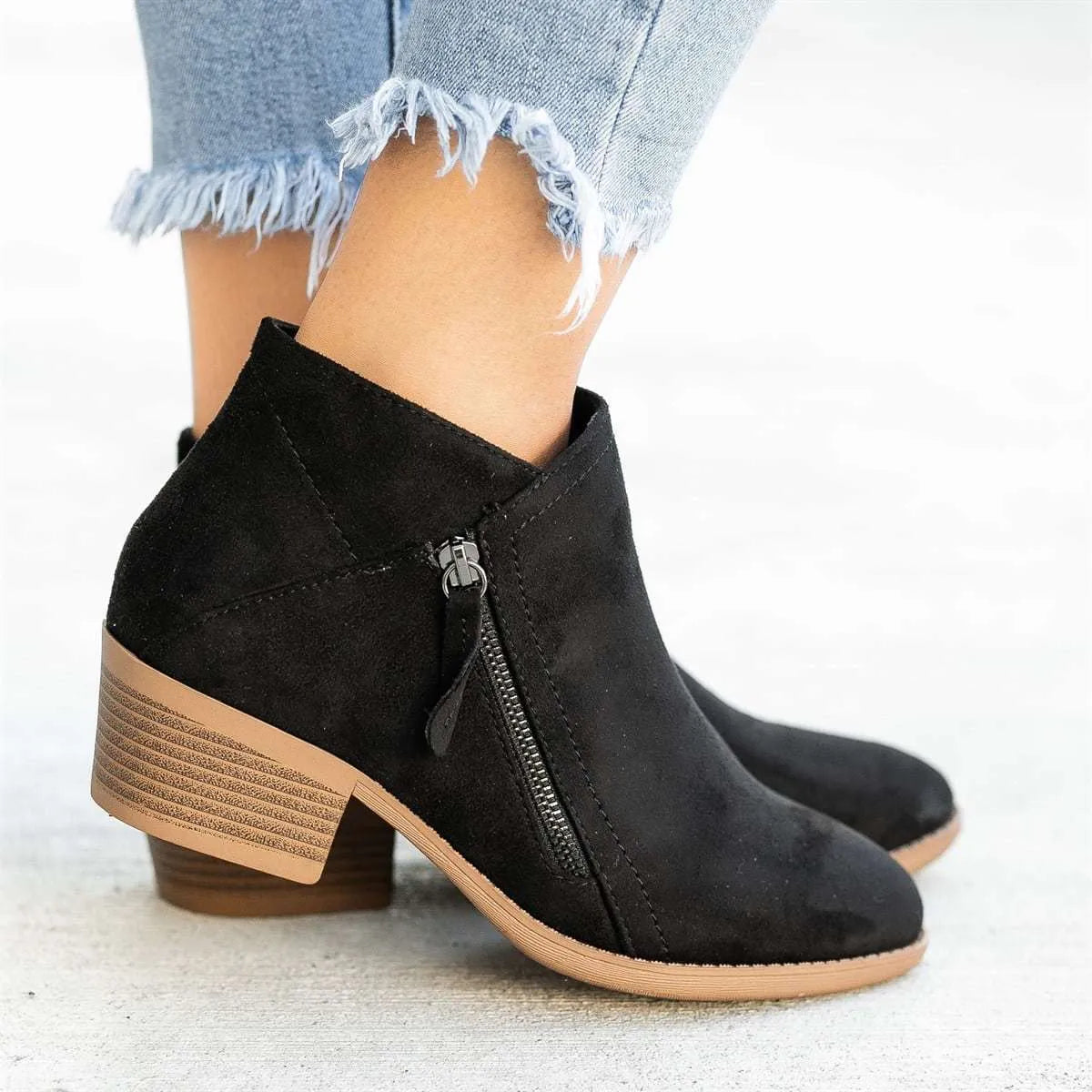 Women's suede ankle boots with a side zip and chunky heel in beige, shown from the side.