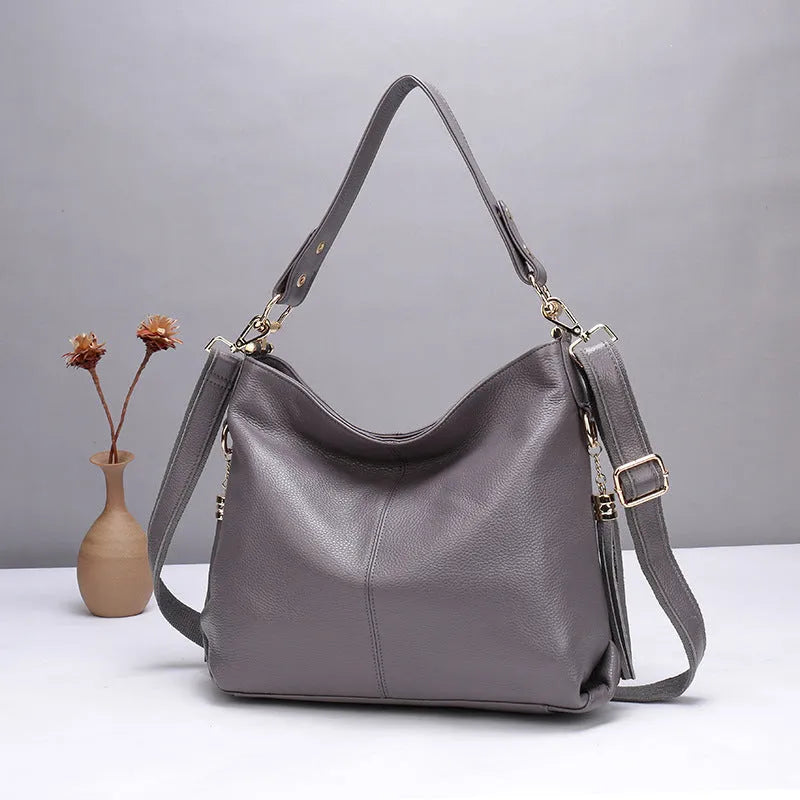 Crossbody bag made from first layer cowhide genuine leather, a medium and soft portable vertical square bag with sandwich pocket, zipper changing bag, mobile phone and document compartments for daily matching in black, grey, taro colour or wine red.