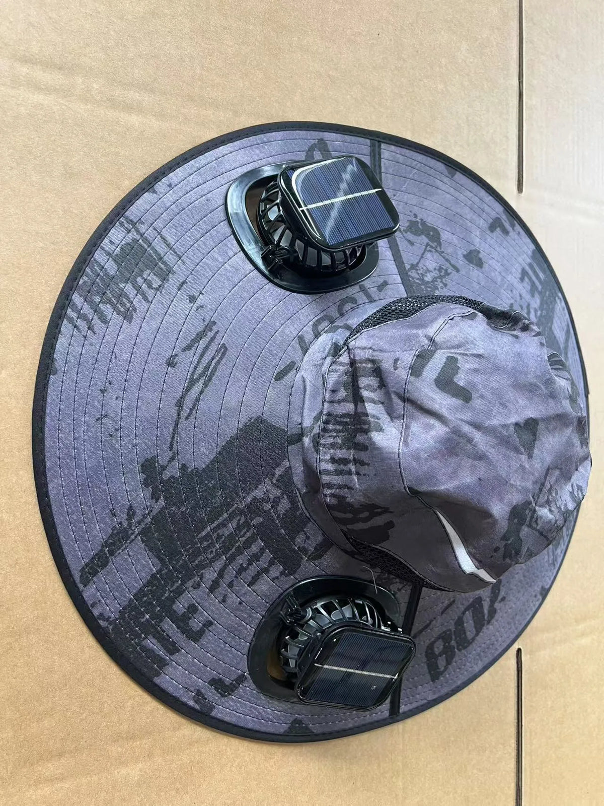 Men's grey solar fan cap with large peak and integrated cooling fans on the front.