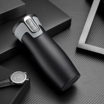 Black vacuum insulated stainless steel travel flask with push-button lid, 450ml capacity.