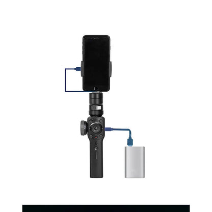 Black mobile phone handheld stabiliser gimbal on table with smartphone mounted