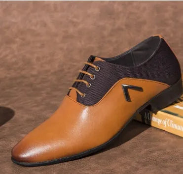 Men's black Oxford dress shoes with a classic toe cap and rubber sole, shown on a wooden floor.
