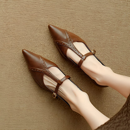 Brown women's pointed toe flat shoes with a round toe and metal detail on a casual cowhide upper.