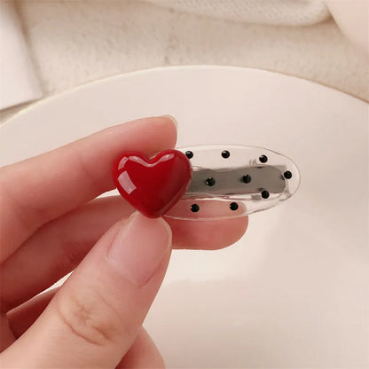Red love heart-shaped hair barrette clip with retro white dots on a willow leaf-shaped base.