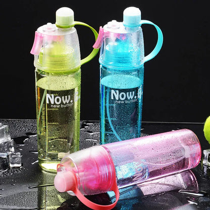 Green mist spray water bottle with clear volume scale and leakproof lid on a wooden table.