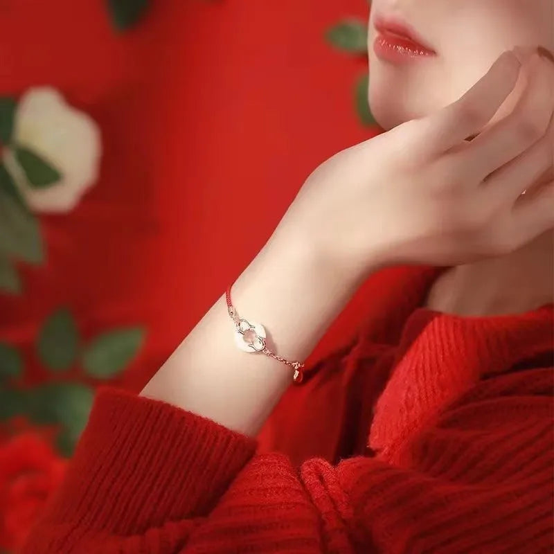 Red rope women's bracelet with electroplated peace buckle and festive koi design elements