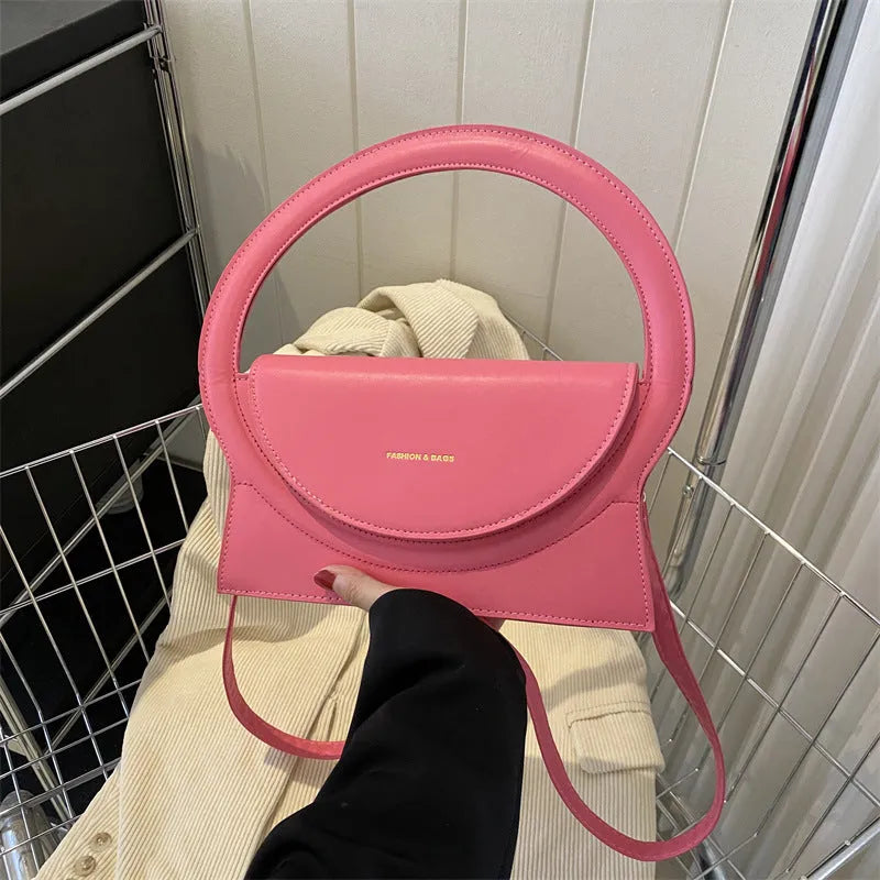 A square-shaped PU messenger bag in a choice of colours, showing external stitching and a sandwich pocket.