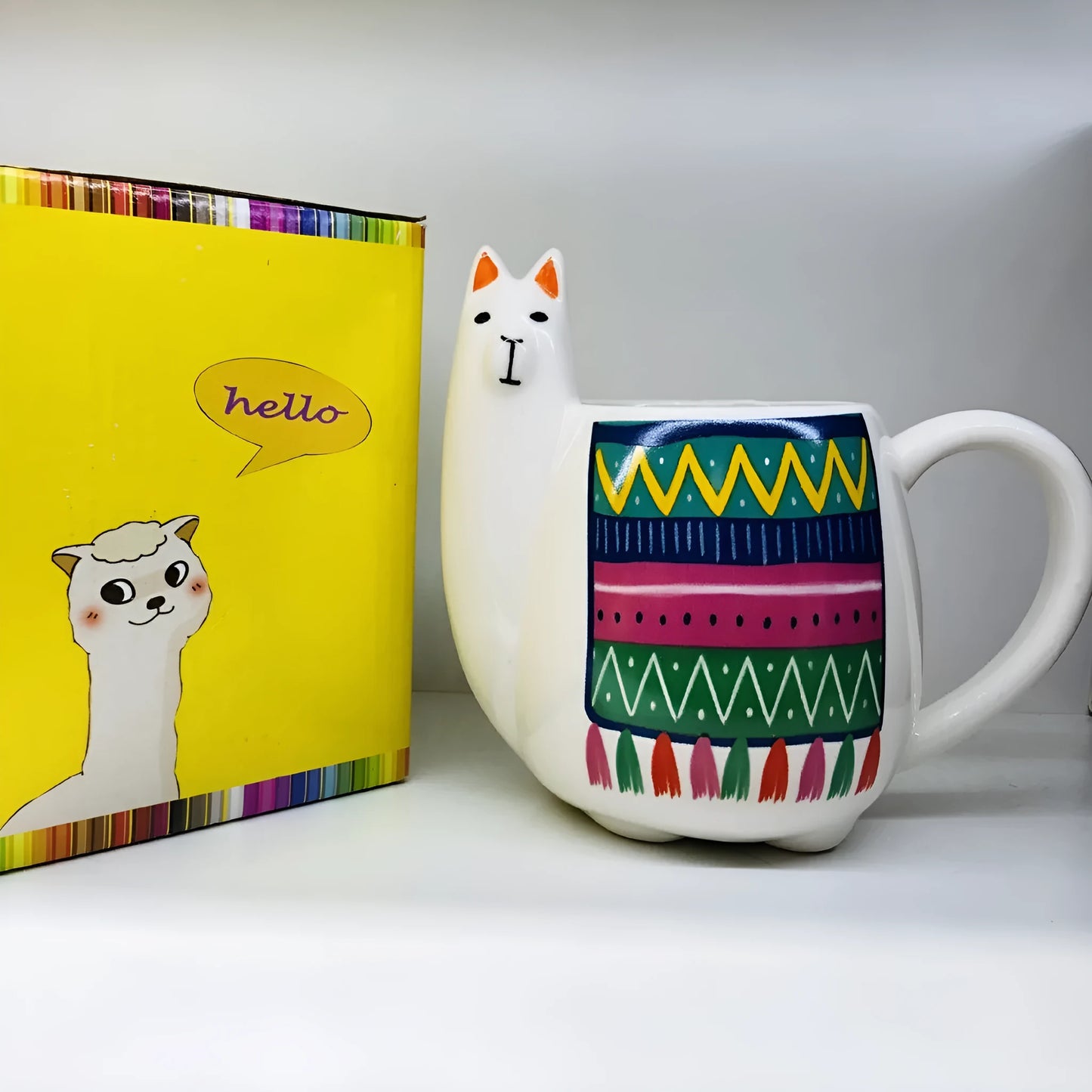 White ceramic mug with cartoon alpaca pattern and handle