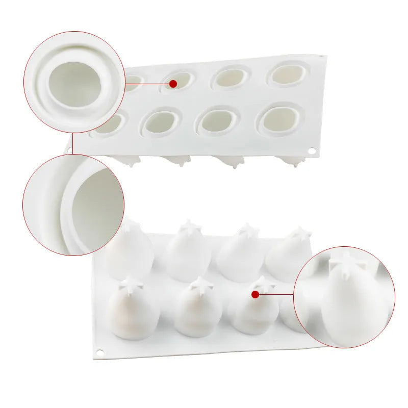 Flexible blue silicone baking mould with six cavities shaped like pineapples and pine cones on a kitchen counter.