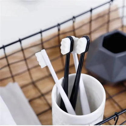 Micron soft toothbrush with coloured handles and different bristle styles including flat head and wavy designs
