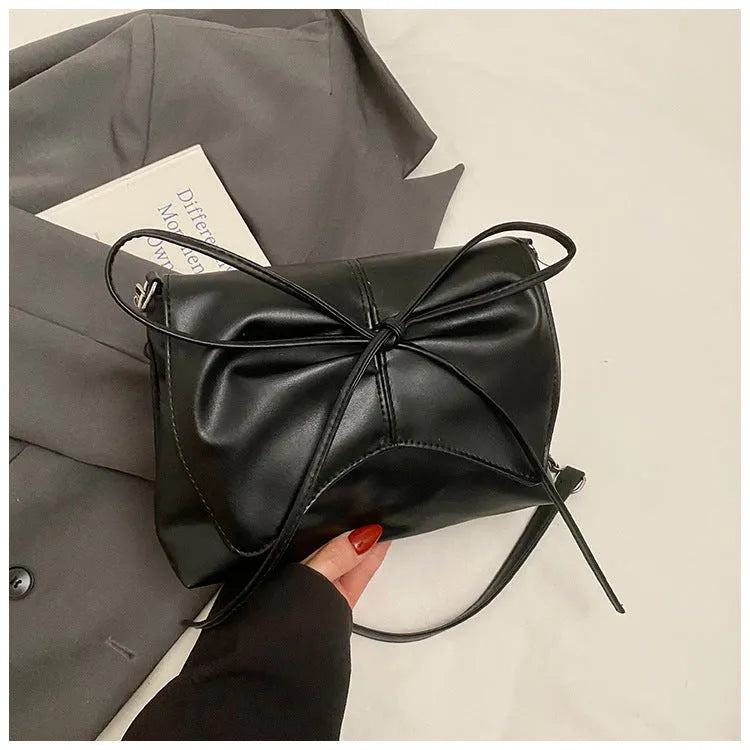 Black horizontal square PU crossbody bag showing internal mobile phone pocket and crossbody strap