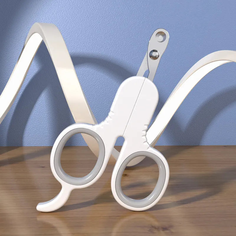 Grey and pink pet nail clippers with curved tips and a rubber-coated ergonomic handle on a table.