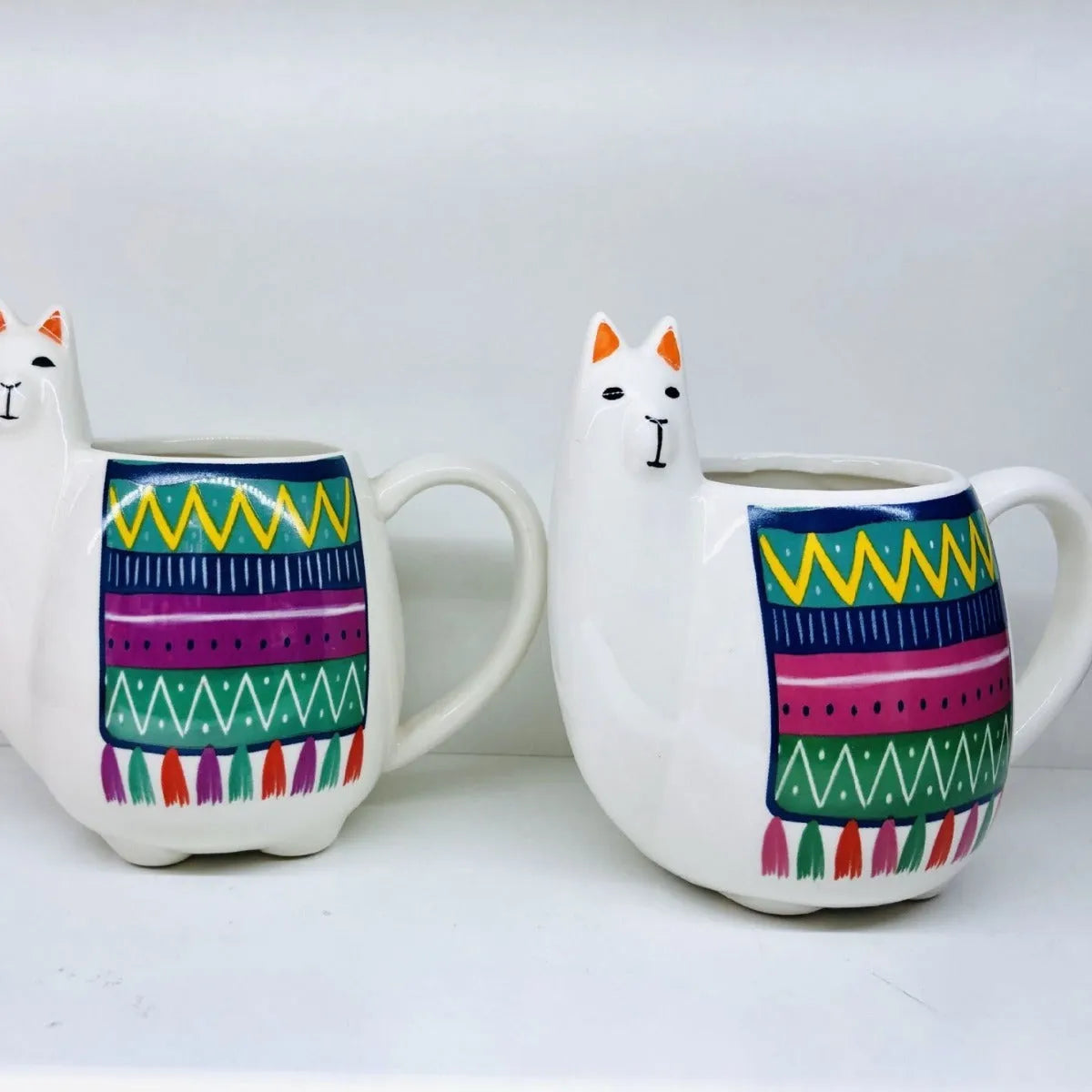 White ceramic mug with cartoon alpaca pattern and handle