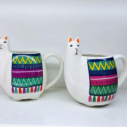 White ceramic mug with cartoon alpaca pattern and handle