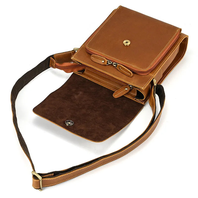 Men's brown first layer cowhide leather shoulder bag with crossbody strap and visible sewing line details.