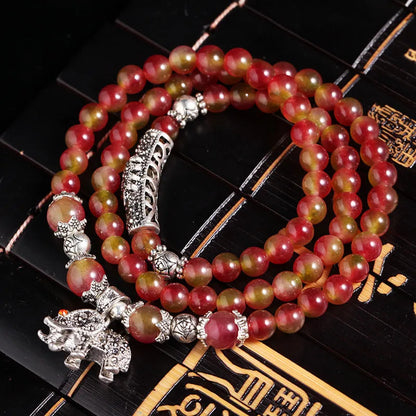 Handmade bracelet with green and pink watermelon crystal beads tied with Chinese knots.