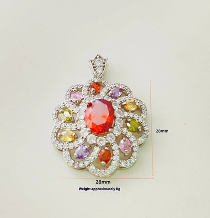 Close-up of a women's flower-shaped pendant necklace with a colourful zircon stone in a choice of gold, champagne gold, or platinum colour finishes.