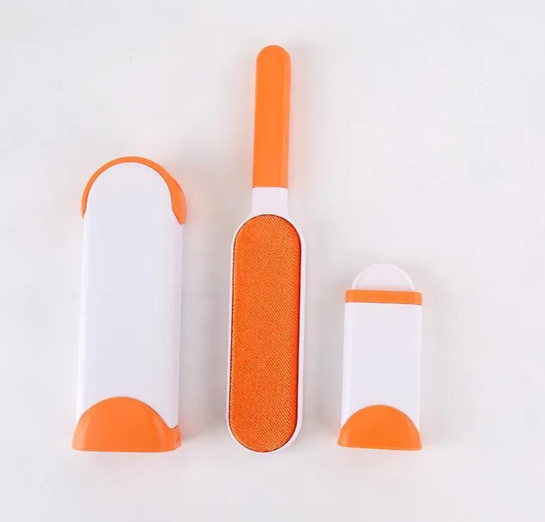 Blue reusable pet hair removal brush with double-sided head next to its self-cleaning base.
