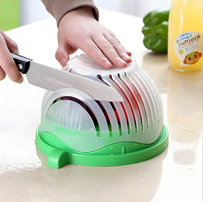 Blue salad cutter bowl showing cutting lid with seams, drain basket function, and reversible base plate