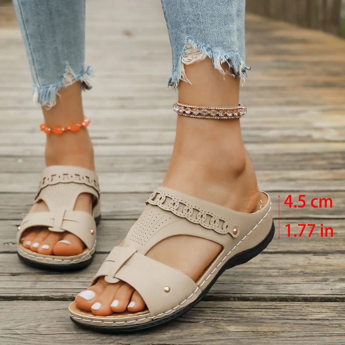 Beige Roman style slippers with a fish mouth toe, slope heel, and rubber sole.