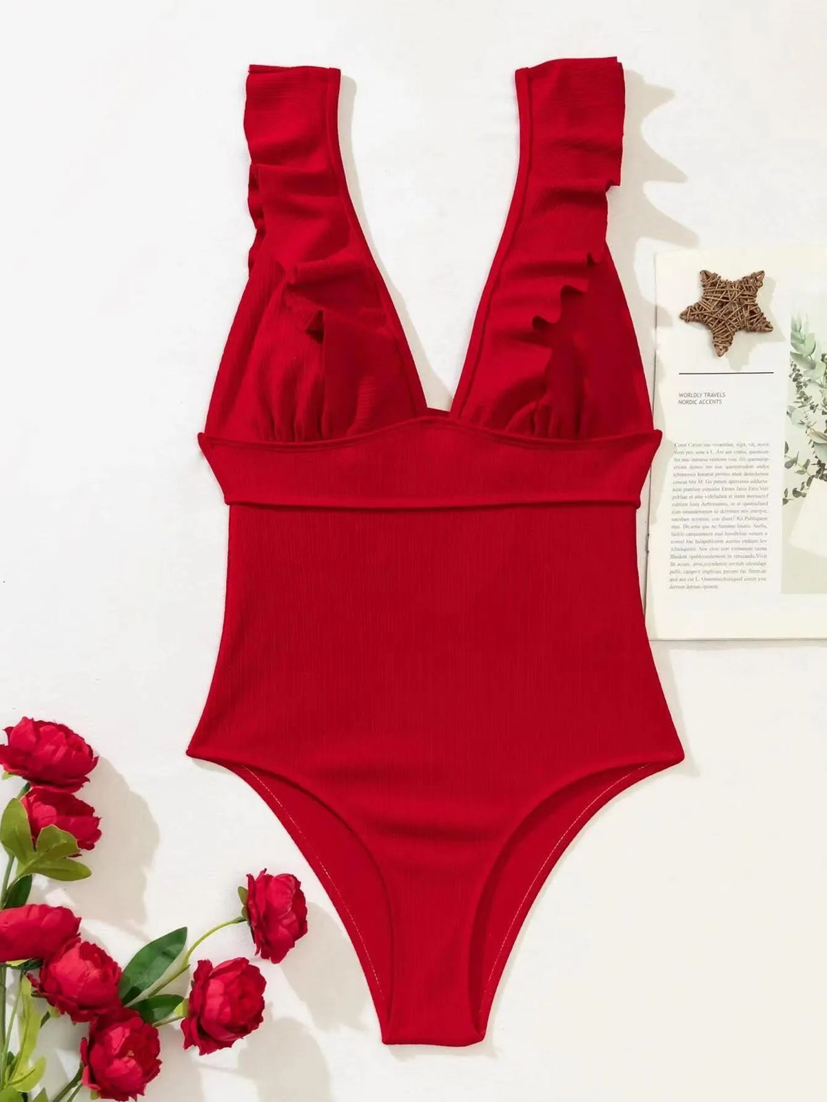 Women's black one-piece swimsuit with ruffled shoulder straps and lace back detail.