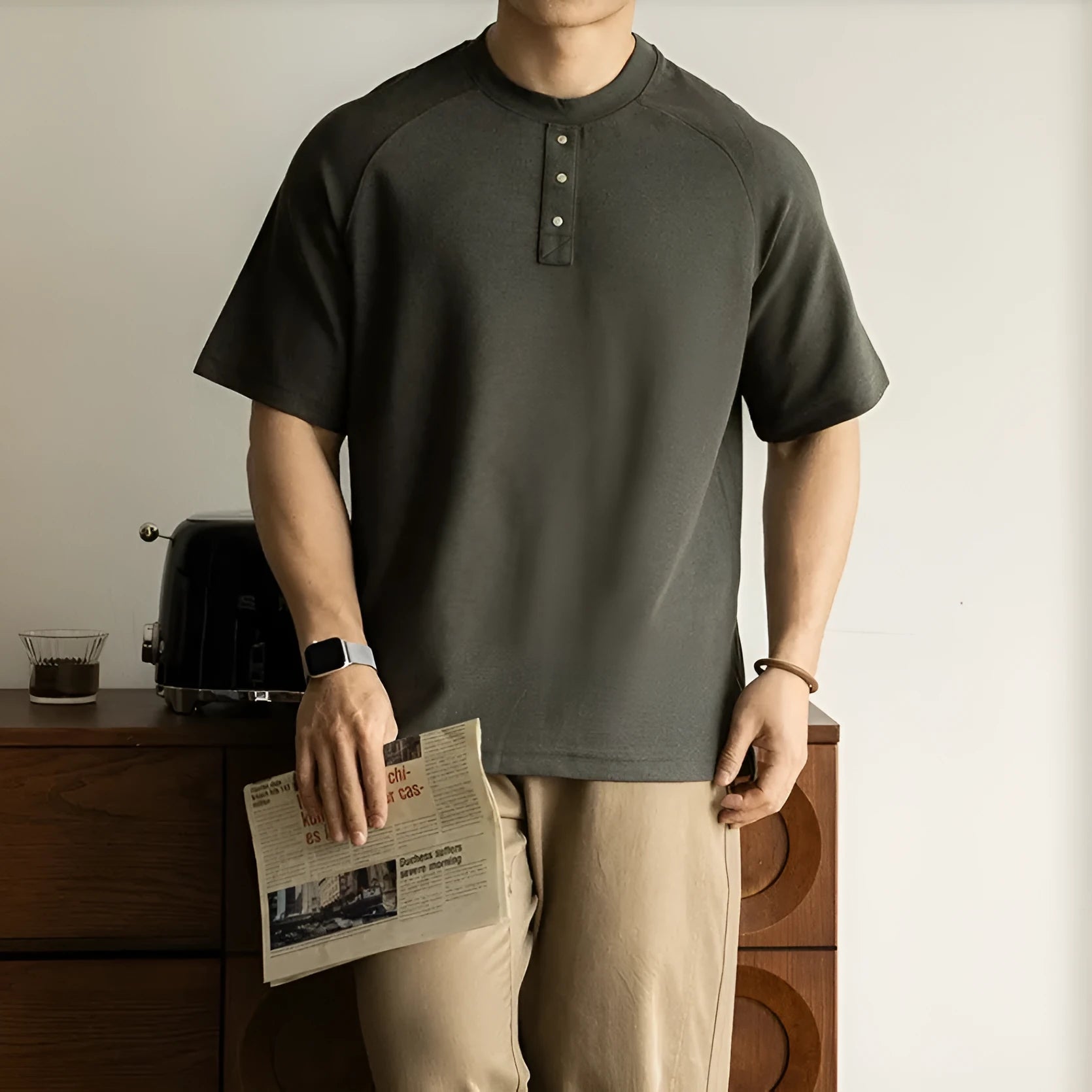 Women's loose grey terry texture casual pullover top with raglan sleeves on a hanger.