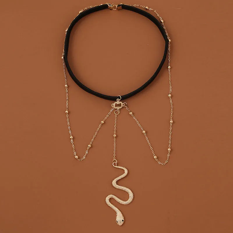 Gold colour alloy thigh chain with big snake pendant and beaded geometric leg chain design