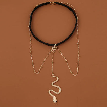 Gold colour alloy thigh chain with big snake pendant and beaded geometric leg chain design
