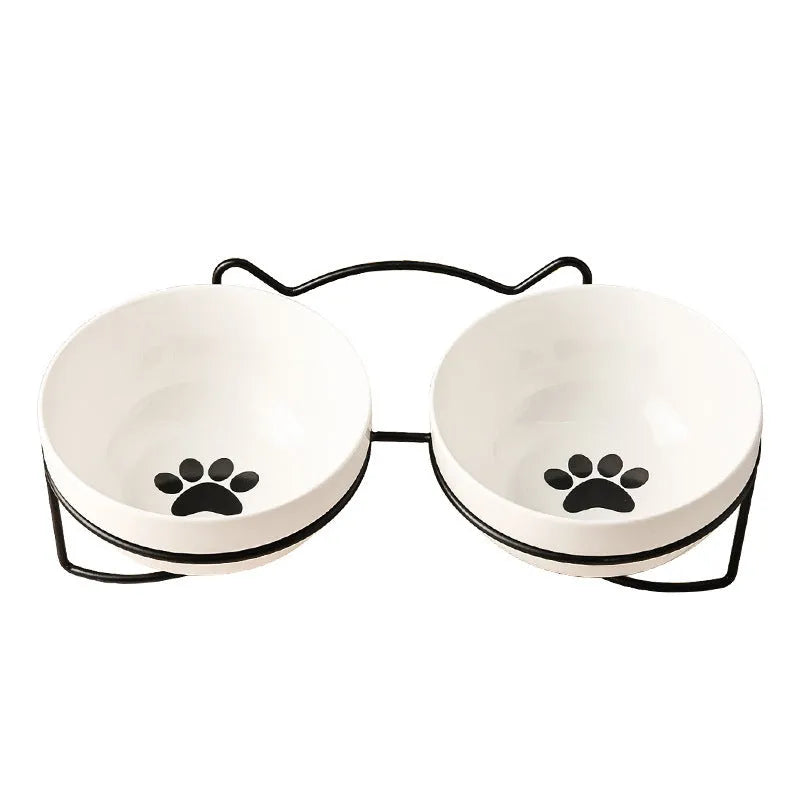 White ceramic pet bowl with cat paw print in a black iron stand with cat ear details