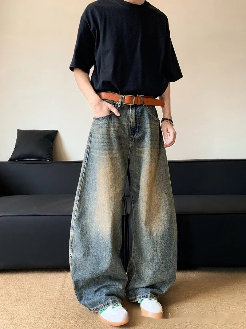 Men's distressed retro blue jeans with a slim wide-leg cut and mid waist.