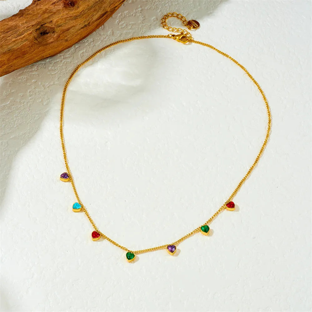 Women's gold-plated heart necklace with adjustable chain on white background
