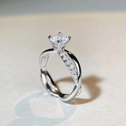 Geometric silver ring with winding twisted arm and 1 karat moissanite stone in four-claw setting