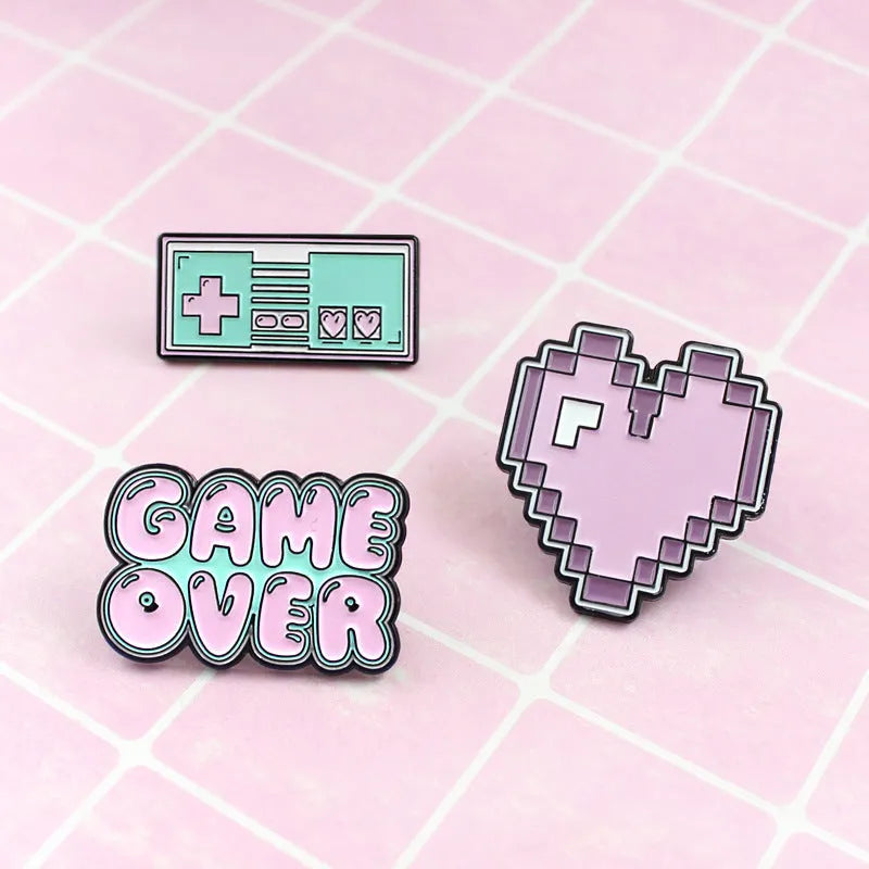 Stereo game console badge made of alloy metal for bag or jacket attachment.
