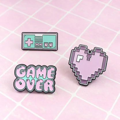 Stereo game console badge made of alloy metal for bag or jacket attachment.