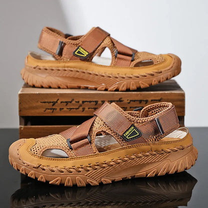 Men's gray casual sandals with mesh panels, leather upper, elastic strap, and rubber sole.