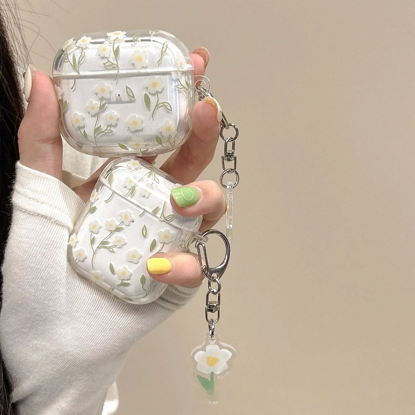 Clear white floral TPU protective cover on an Apple AirPods Pro charging case.