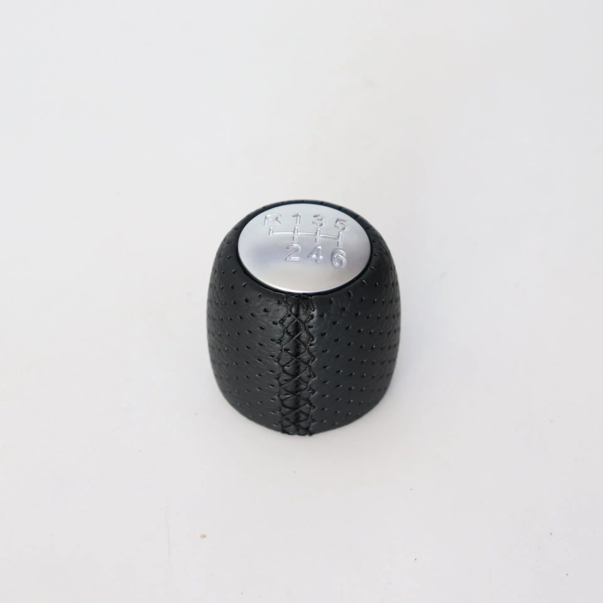 Sewn wrapped leather perforated style handball gear knob for Alpha vehicles in black, red, and white colour options.