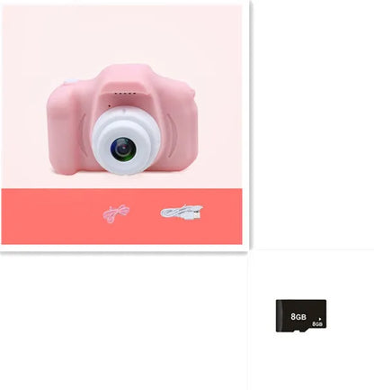 X2 HD mini digital camera for kids in silicone case with lanyard, shown capturing photo on 2-inch screen.