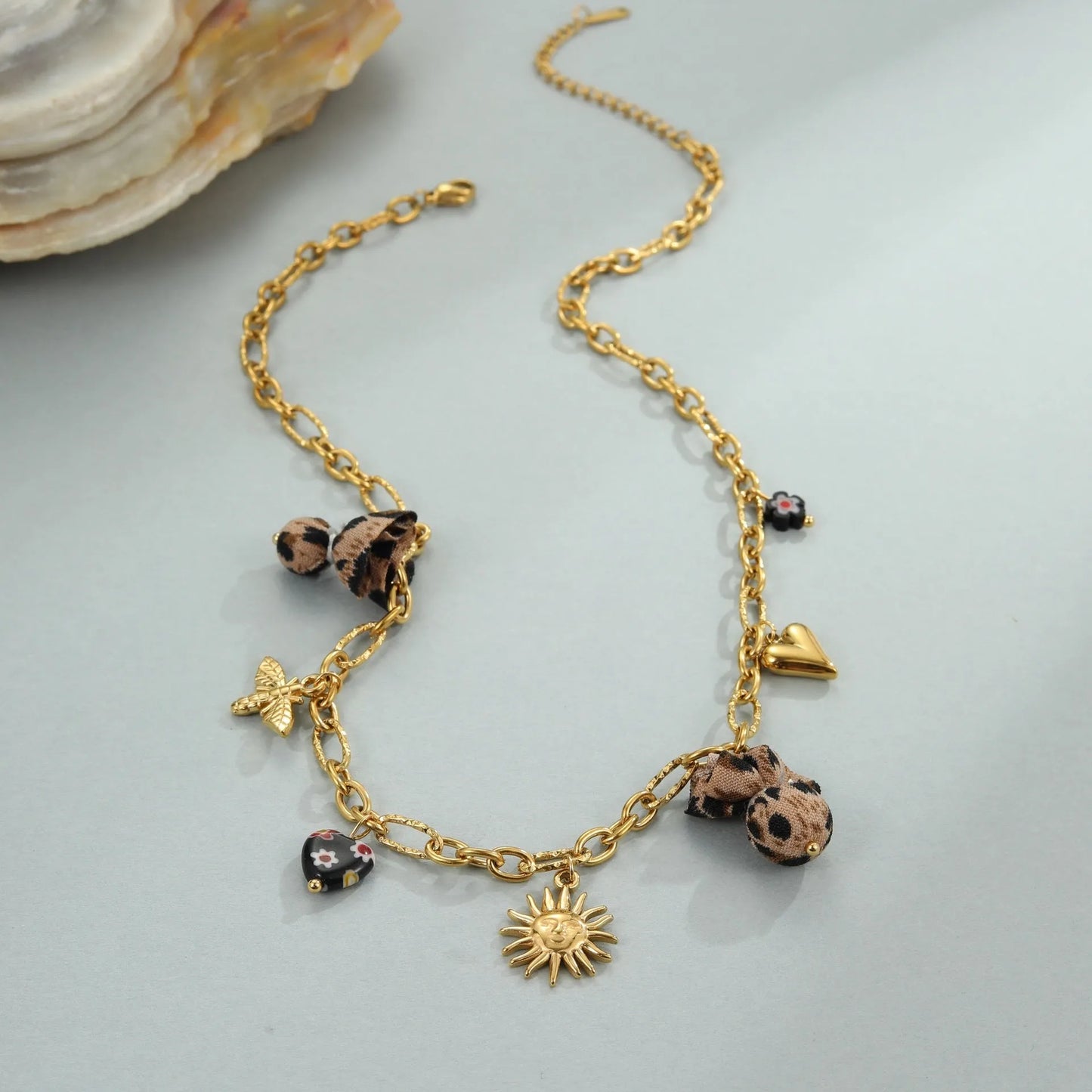 Women's adjustable stainless steel necklace with geometric leopard pendant featuring heart and flower decorative elements
