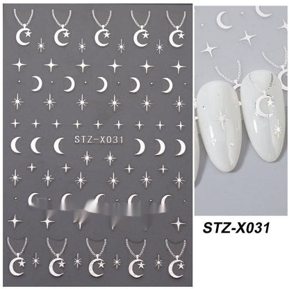 Assortment of black and silver nail sticker designs including cartoon and French tip patterns on a plastic sheet.